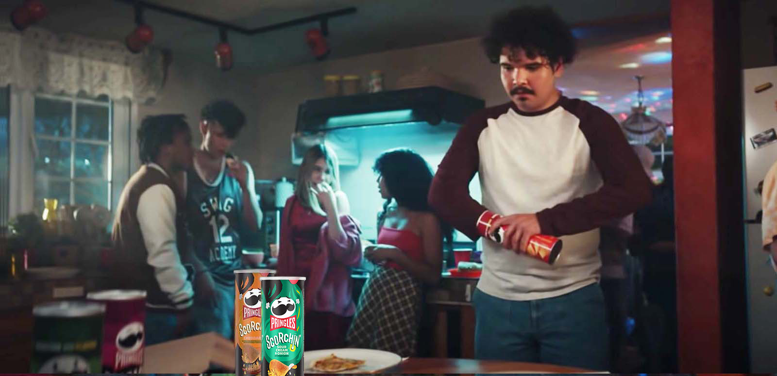 Man shaking his hands which are stuck inside of pringles cans